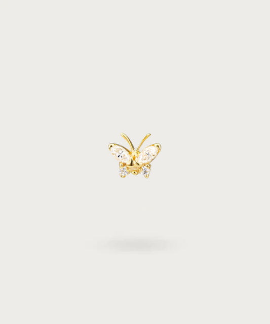 "Close-up view of the gold Butterfly Flat Piercing."