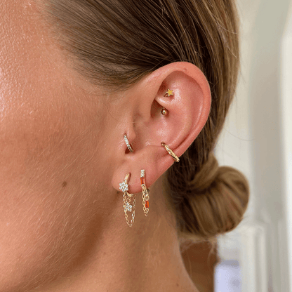 gold star rook piercing worn on a woman