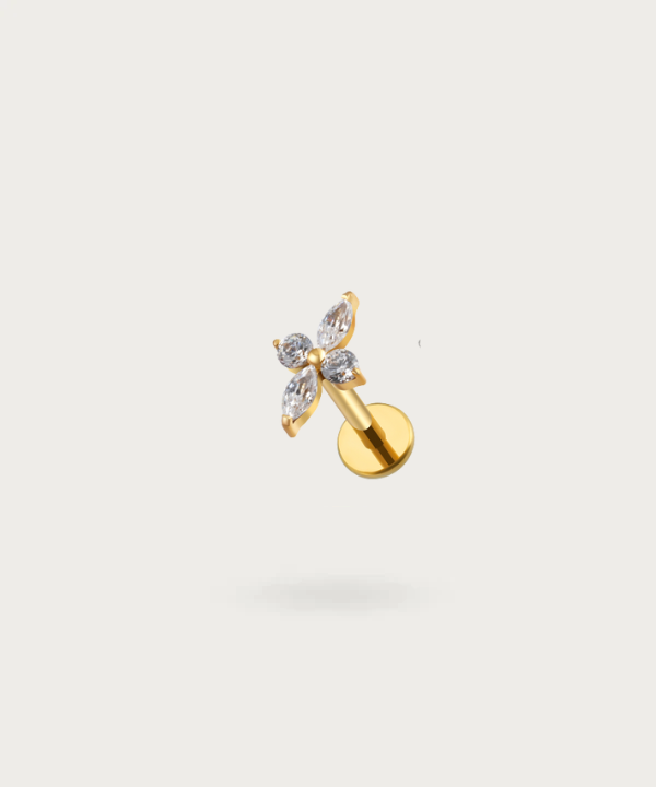 The Flat Flower Piercing on a neutral background, highlighting its delicate floral design.